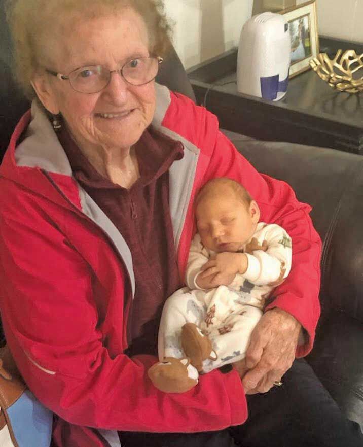 Gustie Unkraut holds one of his many great-grandchildren.